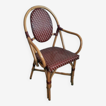 Fauteuil bistrot parisien vintage en rotin/bambou et nylon tressé.