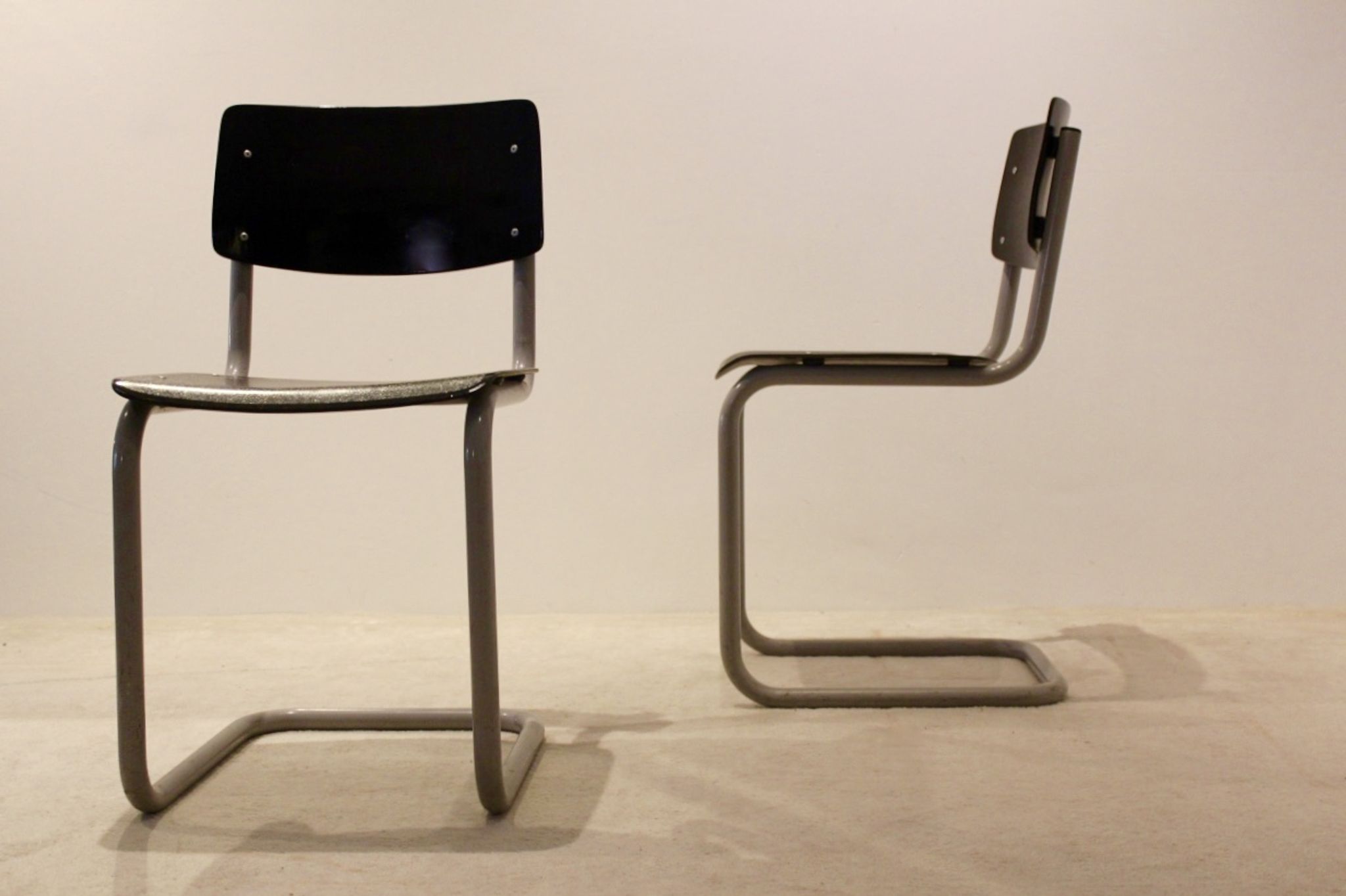 Ensemble de six chaises industrielles en contreplaqué Gispen dans un cadre gris et wengé.