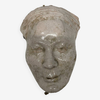 Face of a woman in glazed terracotta