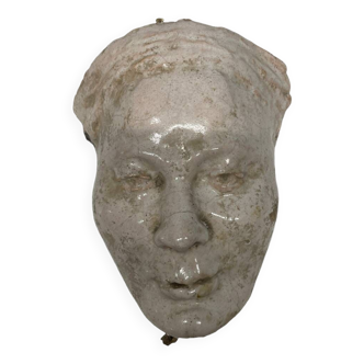 Face of a woman in glazed terracotta