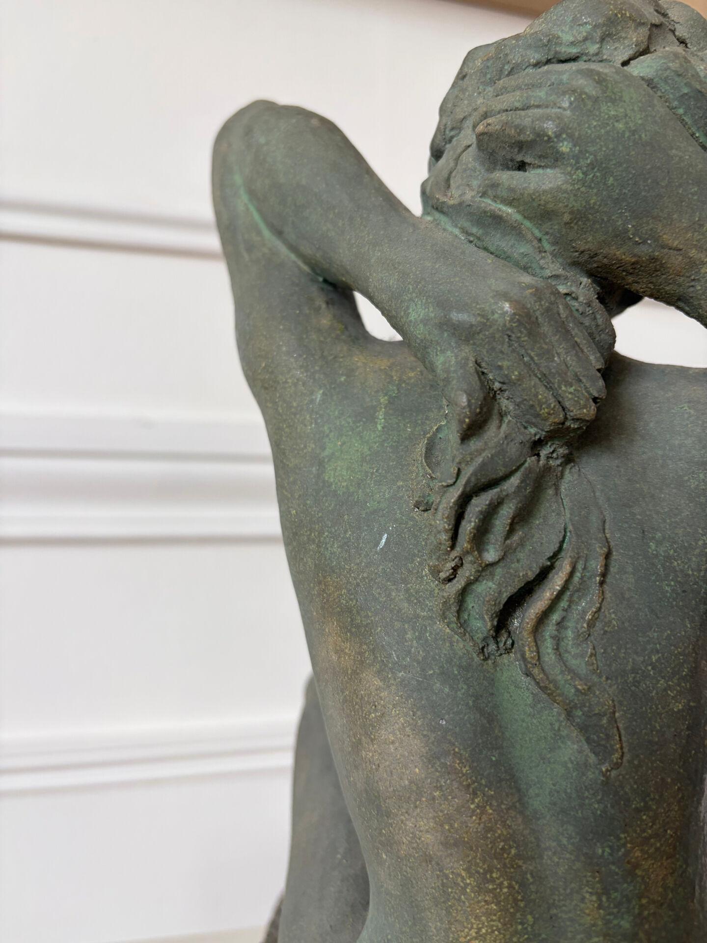 Sculpture of a naked woman titled "Youth" in terracotta.