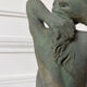 Sculpture of a naked woman titled "Youth" in terracotta.