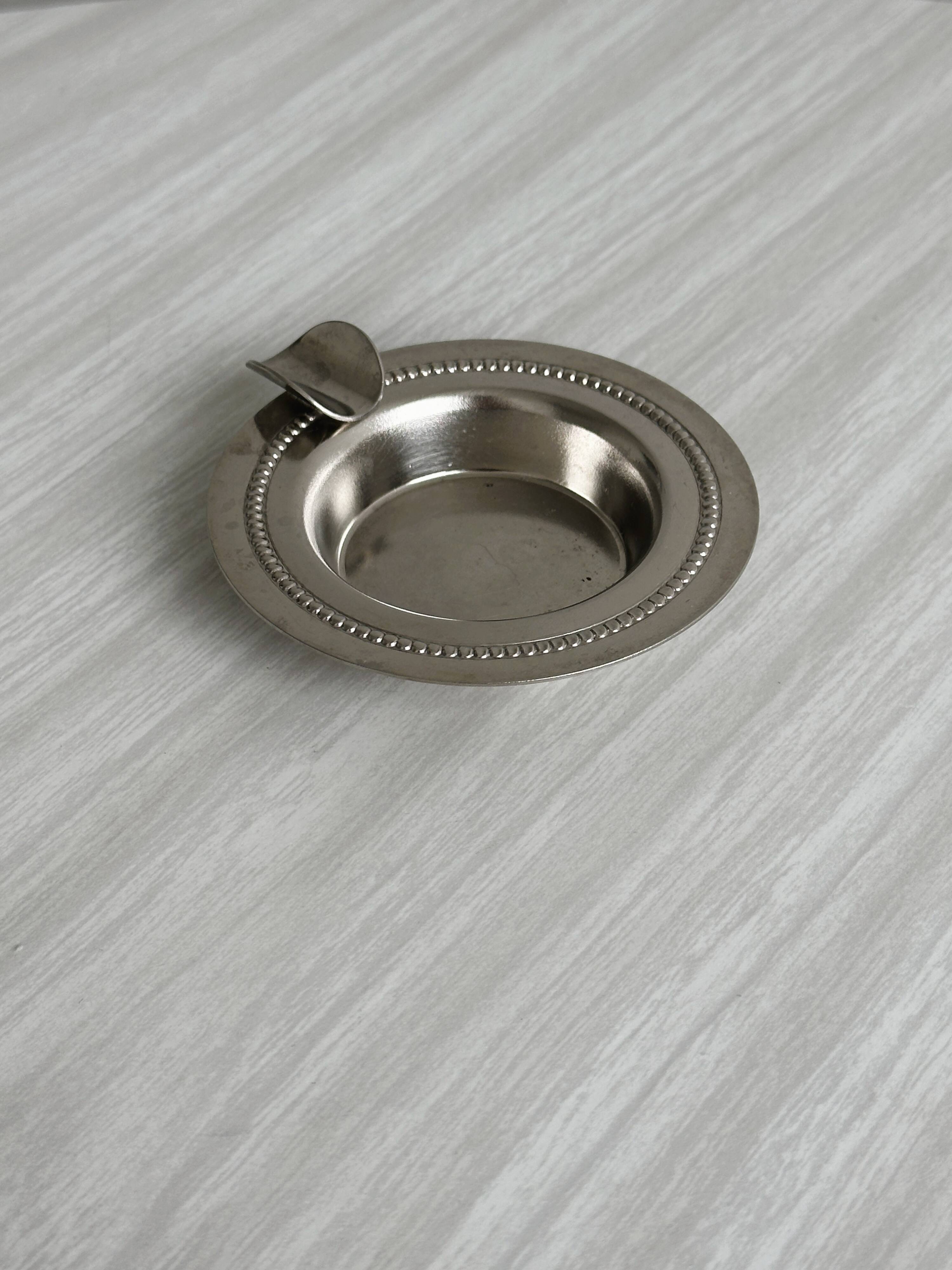 Small ashtray in shiny silver metal