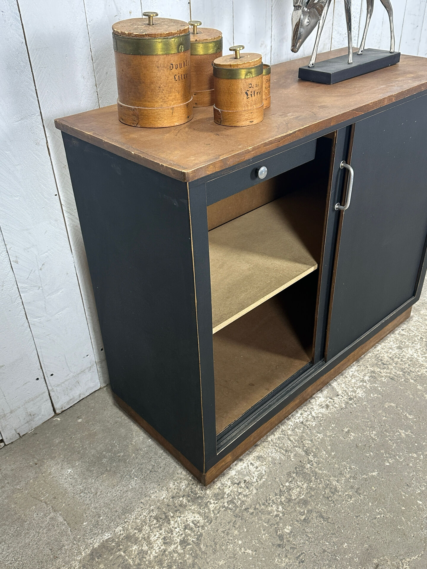 Small vintage black buffet with sliding doors.