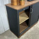 Small vintage black buffet with sliding doors.