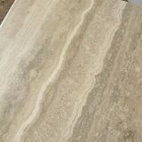 Travertine coffee table in eye shape.