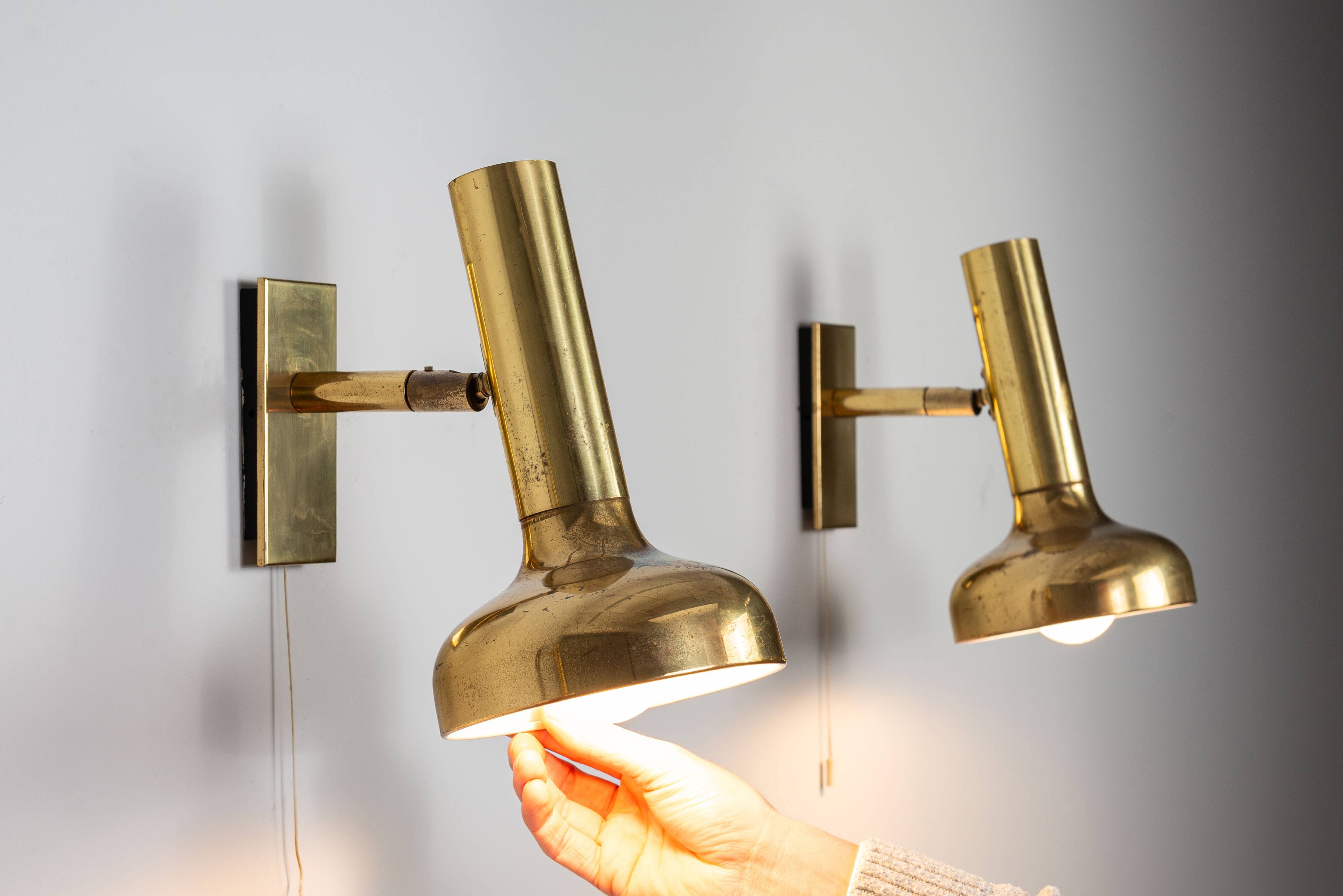Set of three brass adjustable wall lamps
