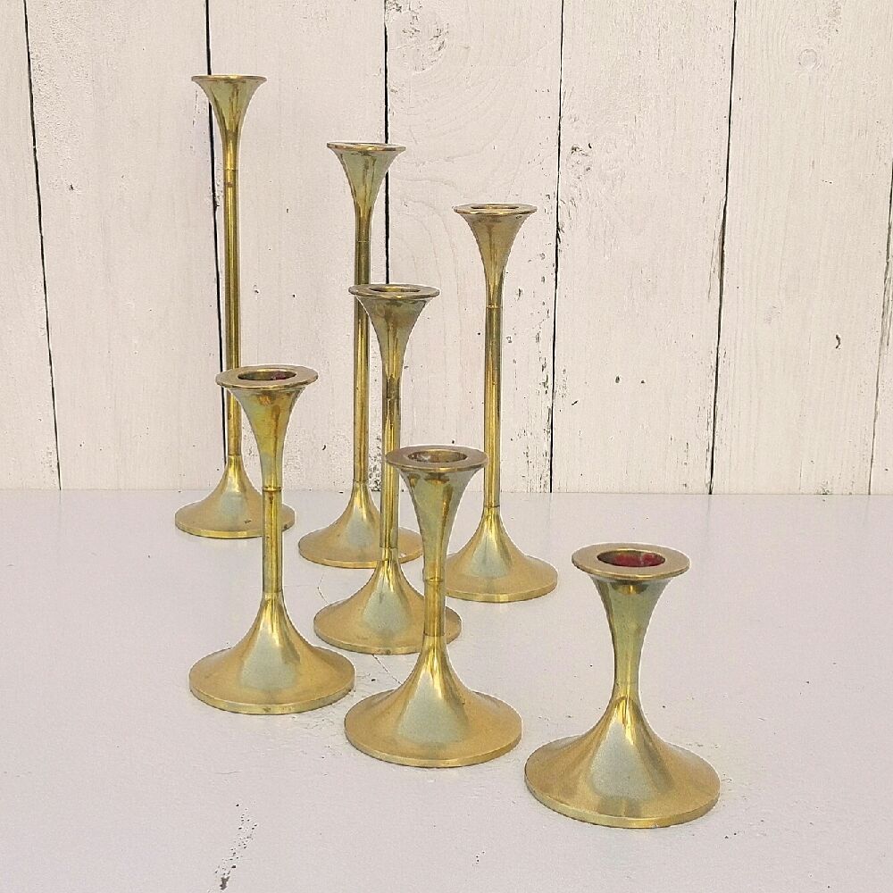 Seven candle holders in golden brass vintage trend