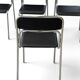 Bauhaus-style tubular steel chairs with black faux leather upholstery, Italian modernist dining room