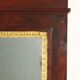 Antique Empire fireplace mirror in mahogany with a bronze frame, Italy, 19th century.