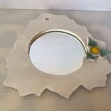 Ceramic mirror with serrated edge and a flower