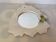 Ceramic mirror with serrated edge and a flower