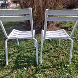 pair of white metal chairs, Tolix style