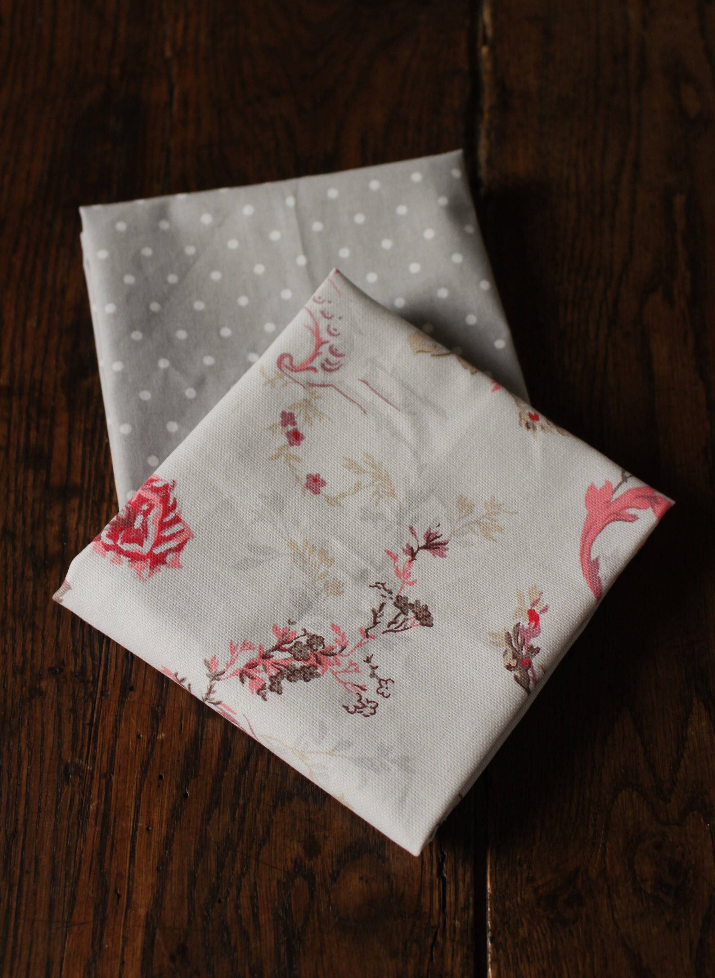 A set of 8 gray blue napkins with pink flowers and polka dots