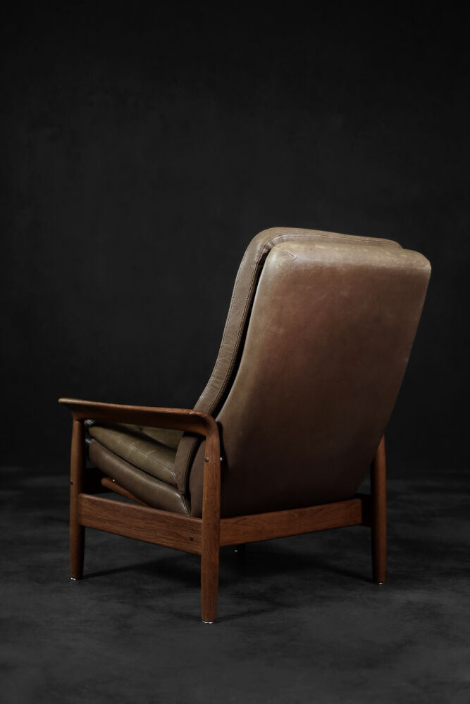 High teak and brown leather armchair with reclining backrest, mid-century Danish style, 1960s.