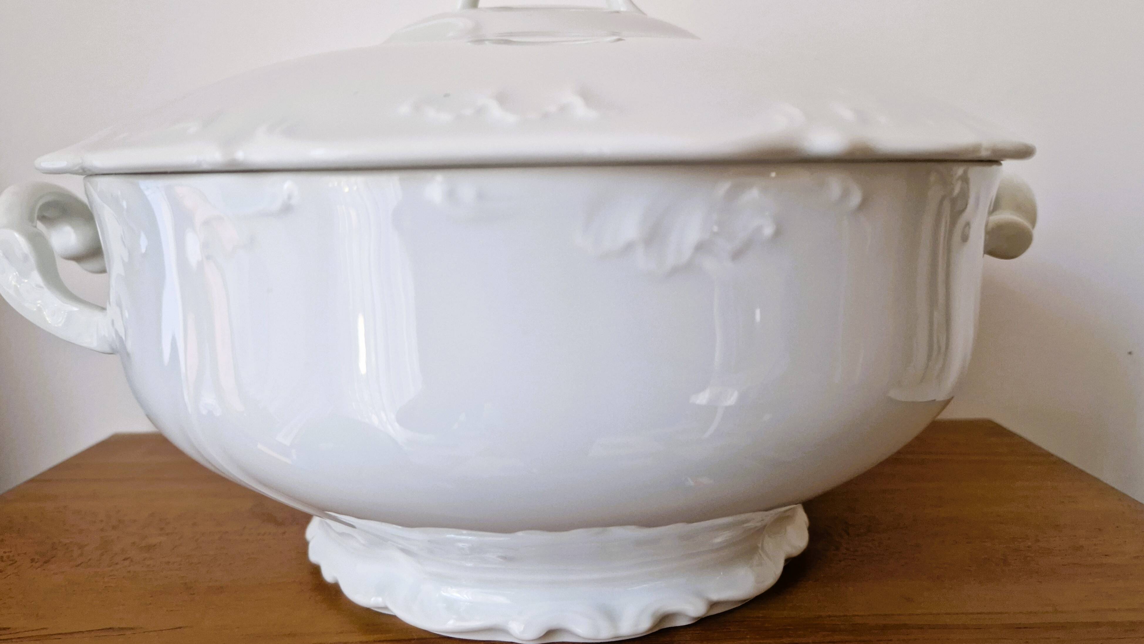 White porcelain soup tureen from Limoges with a vegetal scroll design.