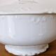 White porcelain soup tureen from Limoges with a vegetal scroll design.