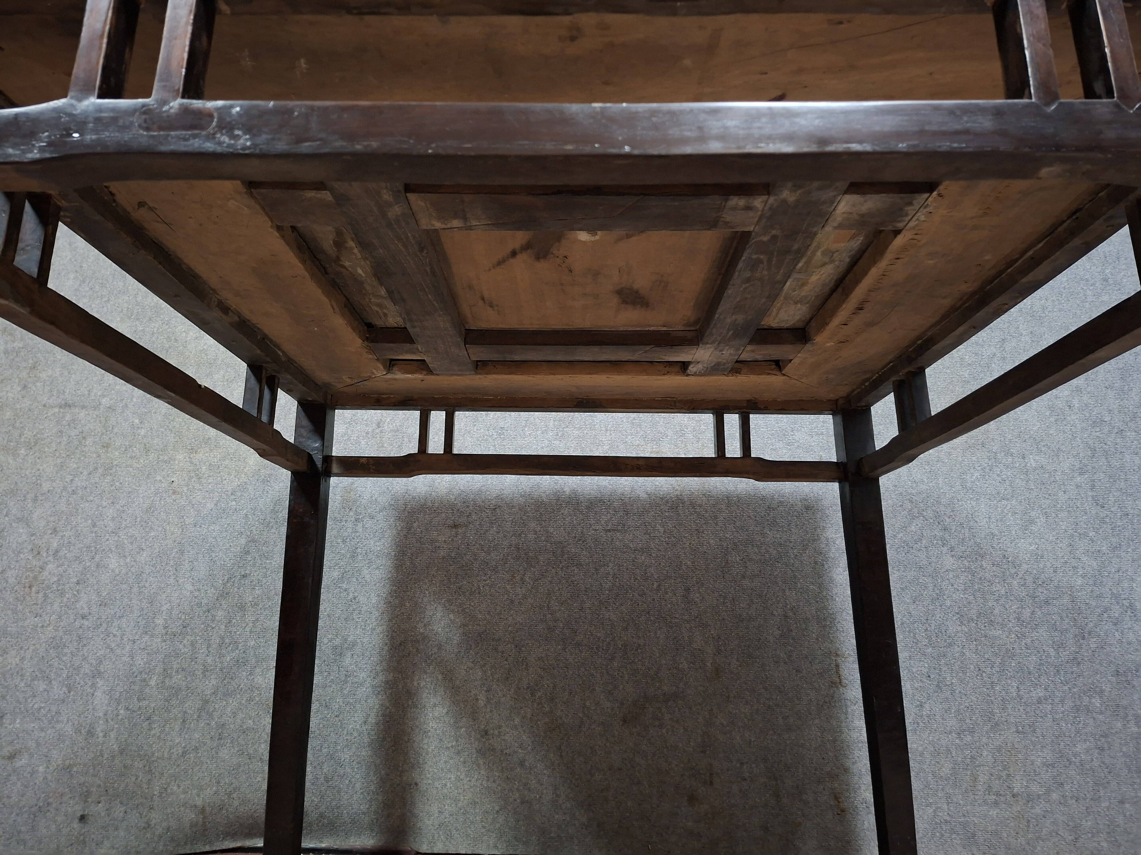 ancient Asian table, made of solid wood with a dark brown patina