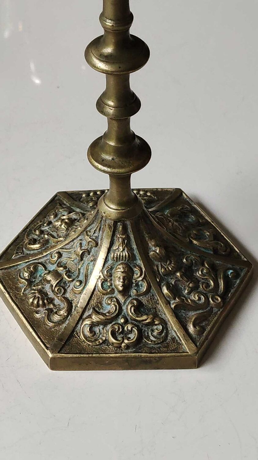 Baroque/Antique style torch candleholder, nineteenth, gilded bronze. Head motifs, volute arabesques