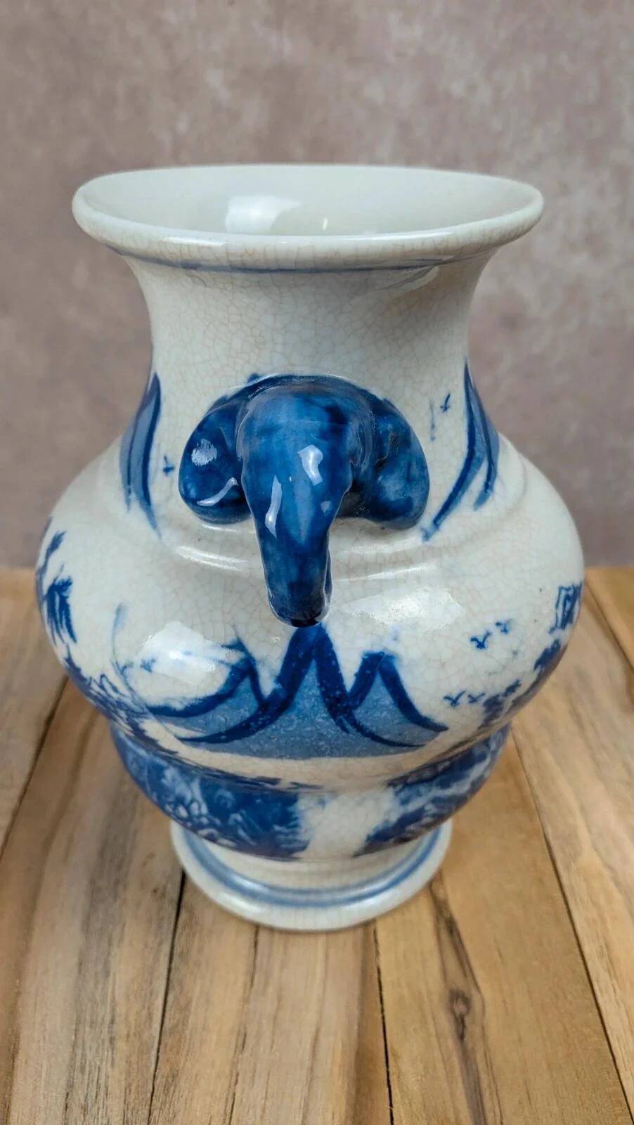 Blue and white Chinese vase with sculpted handles and landscape decoration.