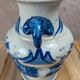 Blue and white Chinese vase with sculpted handles and landscape decoration.