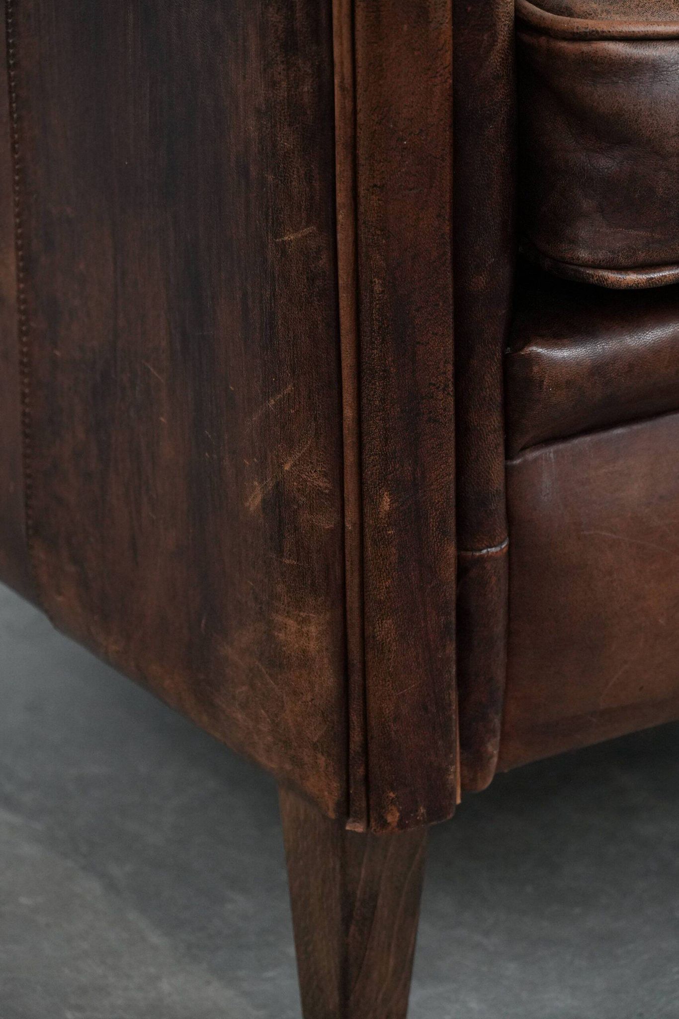Vintage sheepskin armchair with warm colours and a characterful appearance