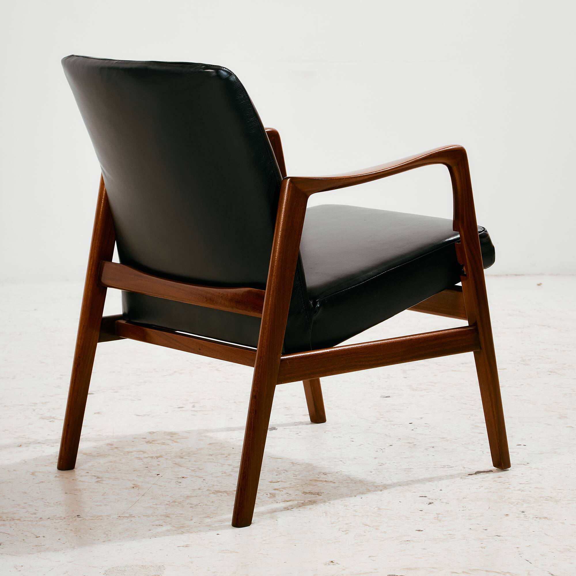 Teak armchair with leather upholstery
