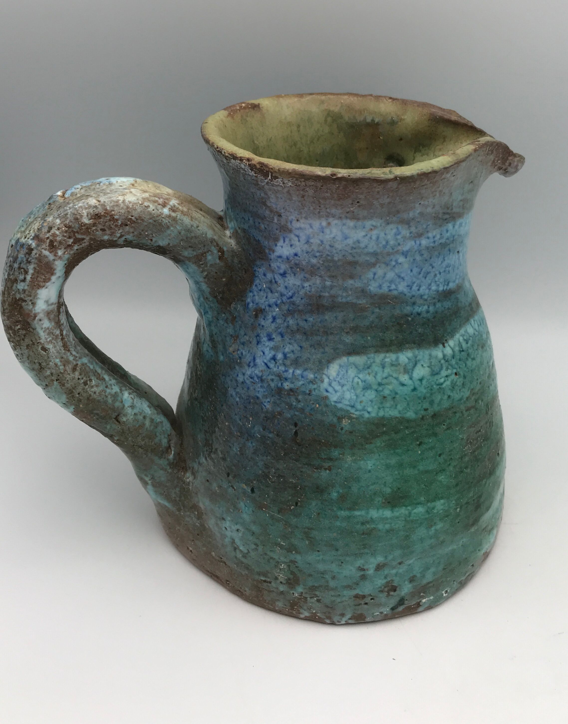 Vintage broc pitcher in enamelled sandstone with effect of blue shades, turquoise green signed