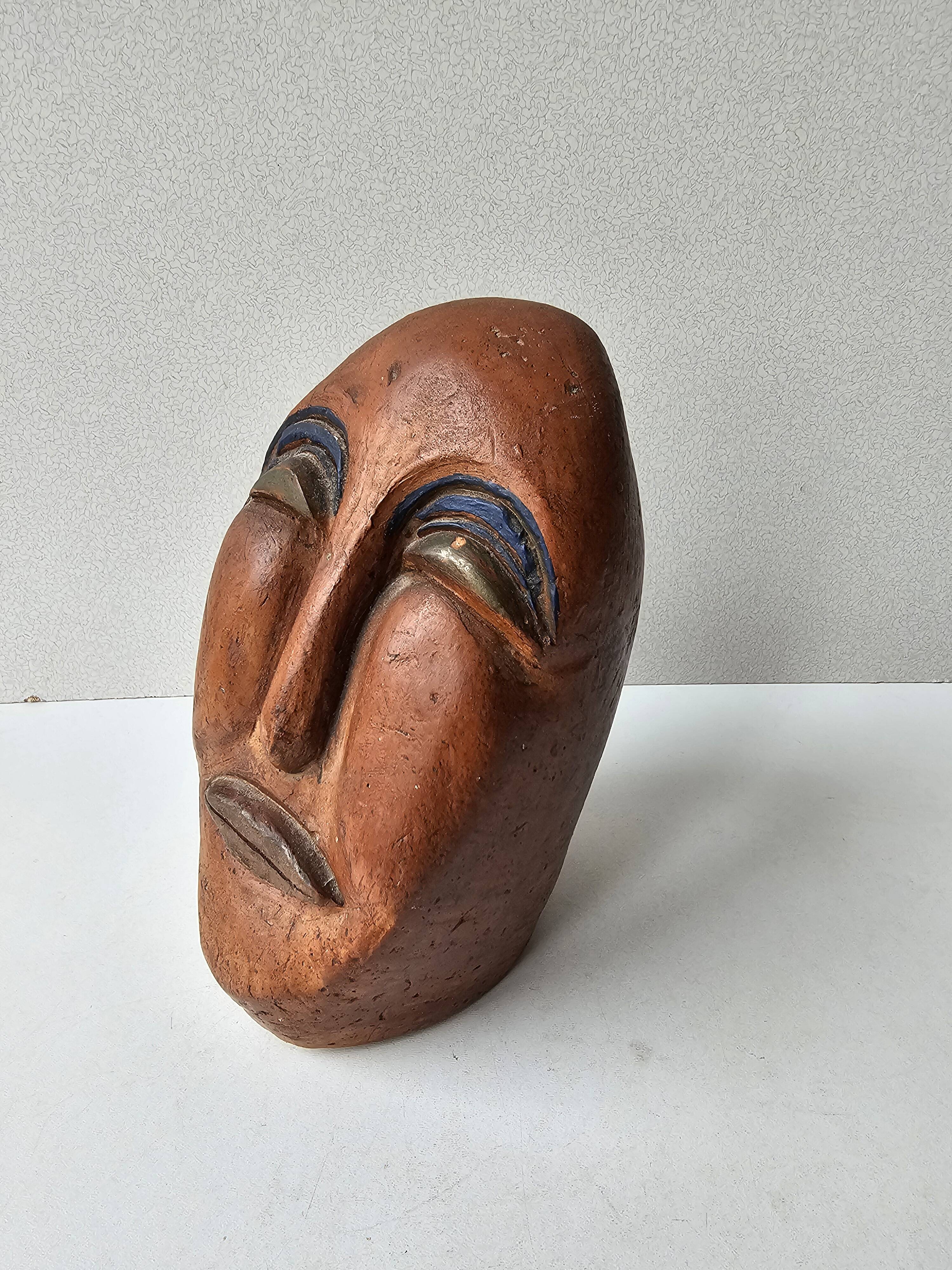 Terracotta face sculpture in African art style