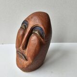 Terracotta face sculpture in African art style