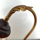 Gold swan neck table lamp with amber tulip glass.