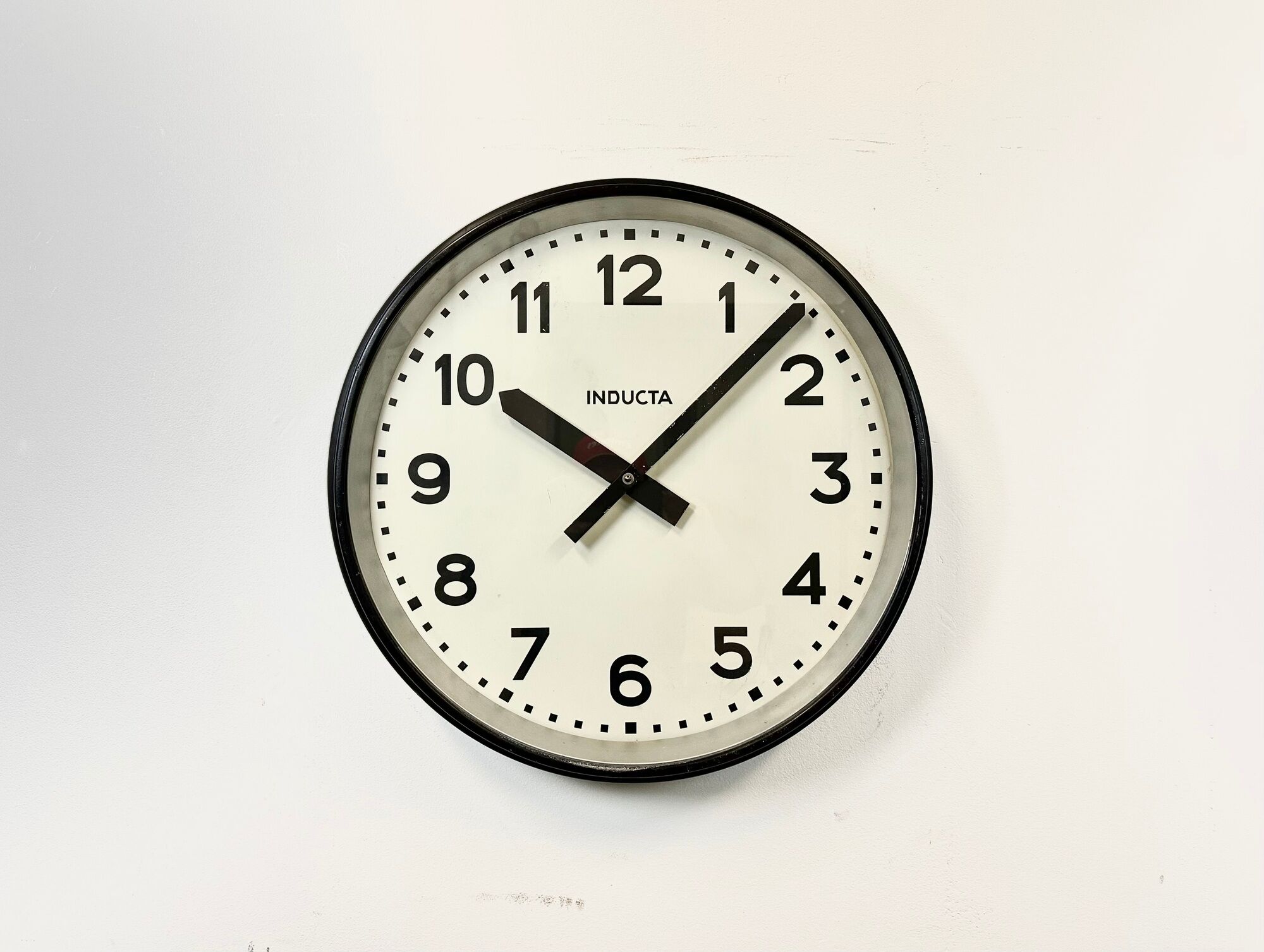Black swiss industrial wall clock from inducta, 1960s