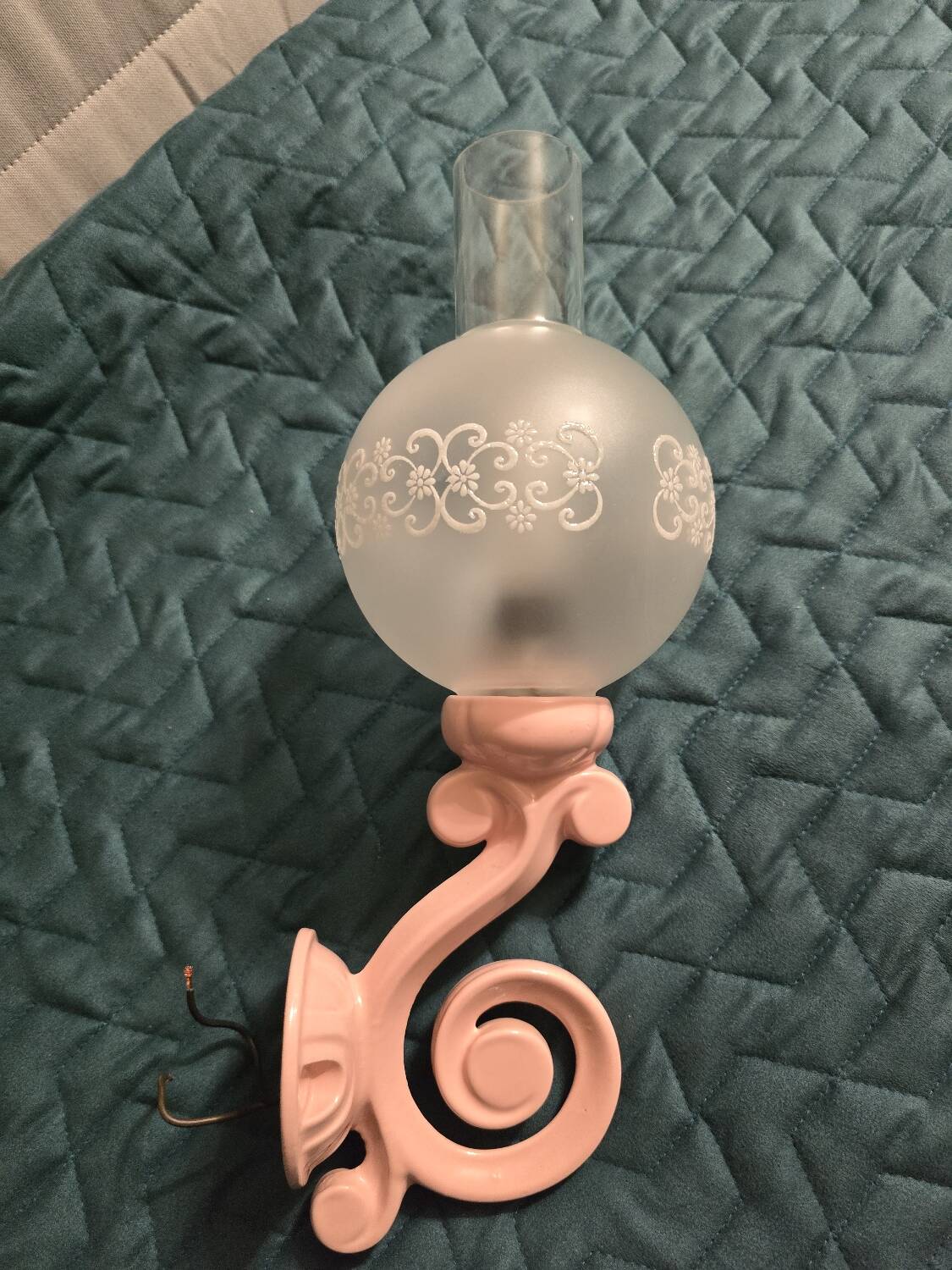 Original wall lights in pink enamelled cast iron with frosted glass globes.