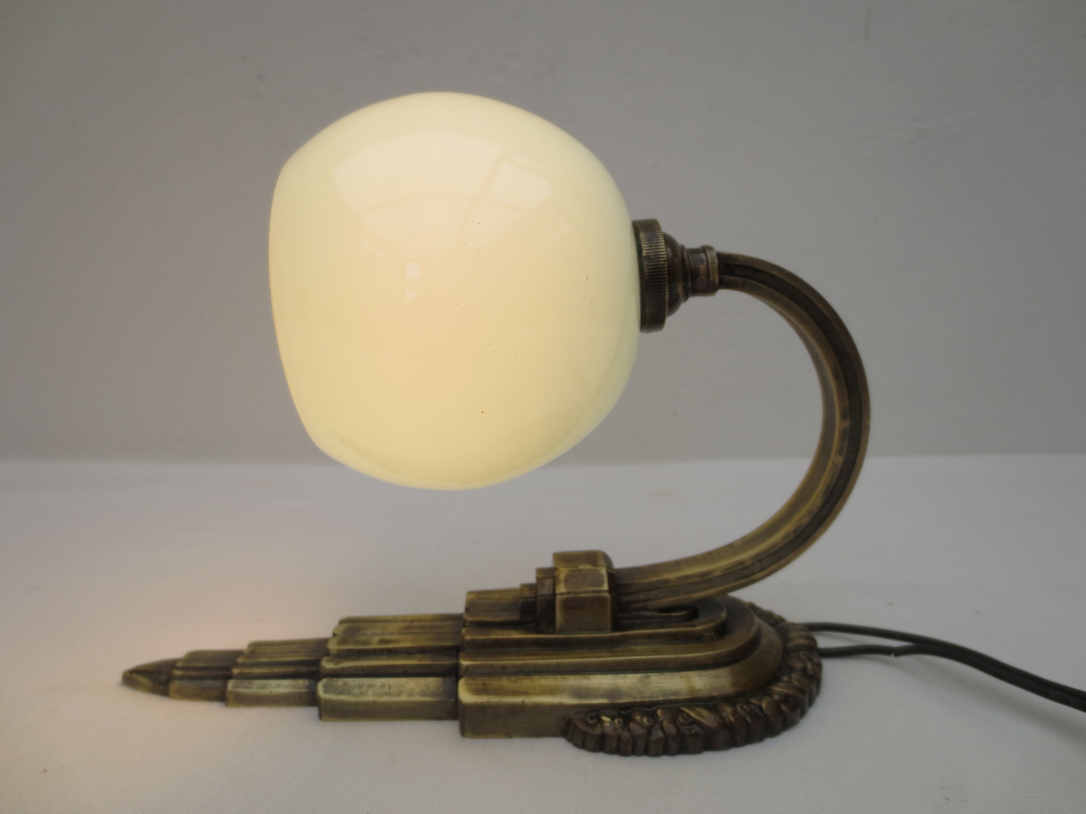 Art deco wall lamp in brass and soft blue opaline globe