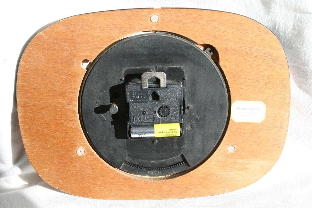 Vintage wall clock in orange formica