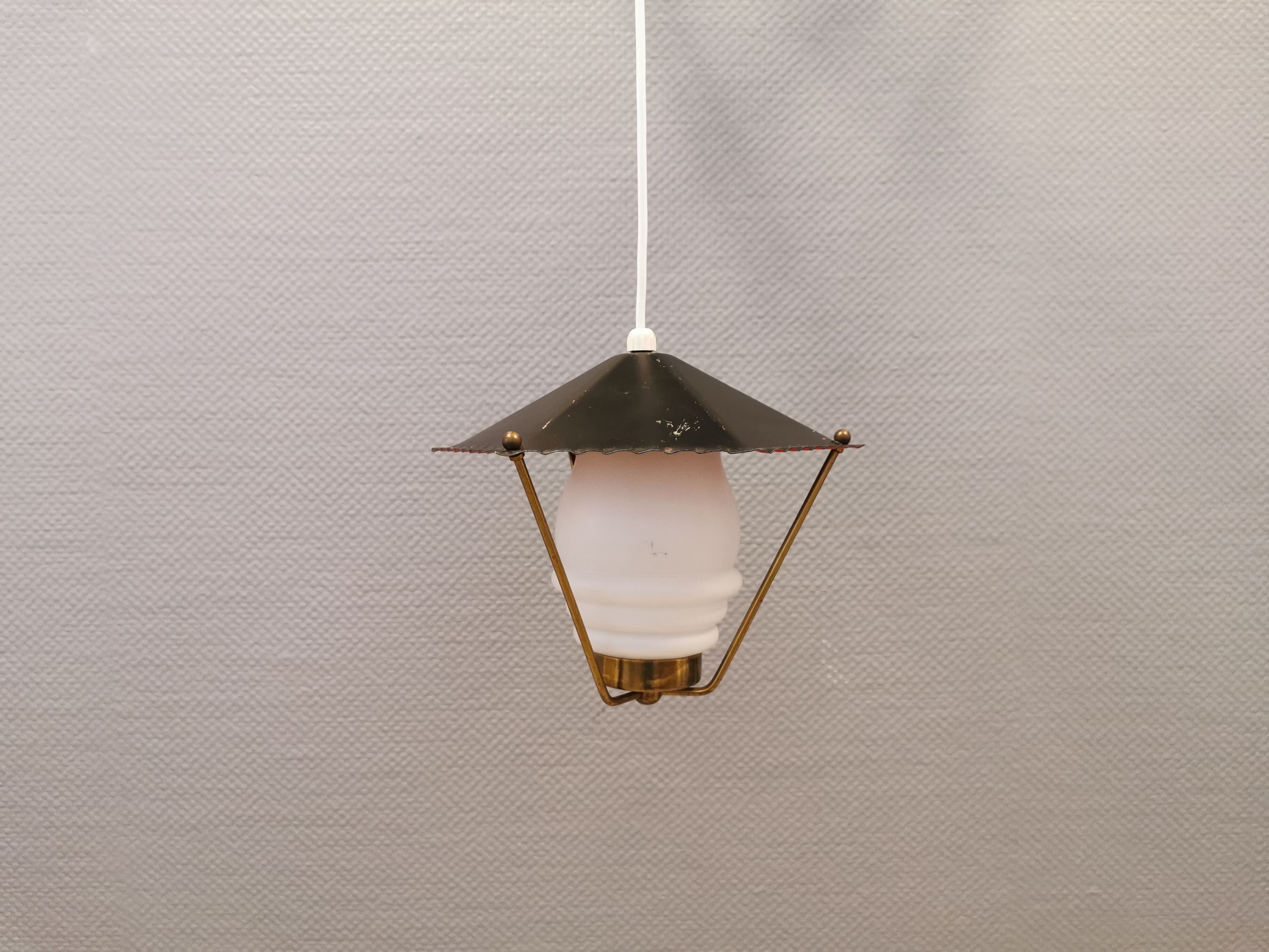 Danish hanging lamp from the 50-60s, made of brass, metal and with milky white glass shade.