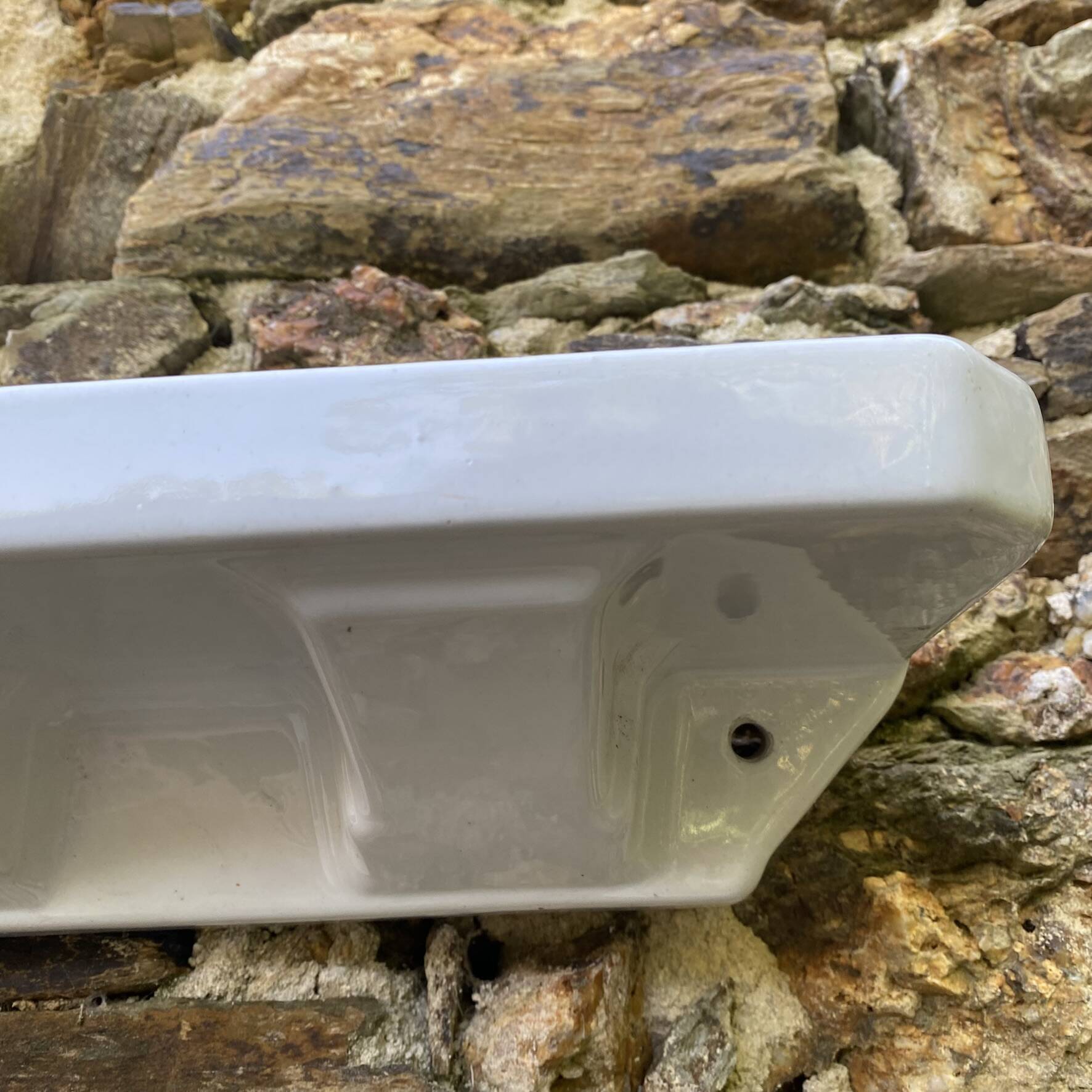 Antique wall shelf for bathroom in white porcelain.