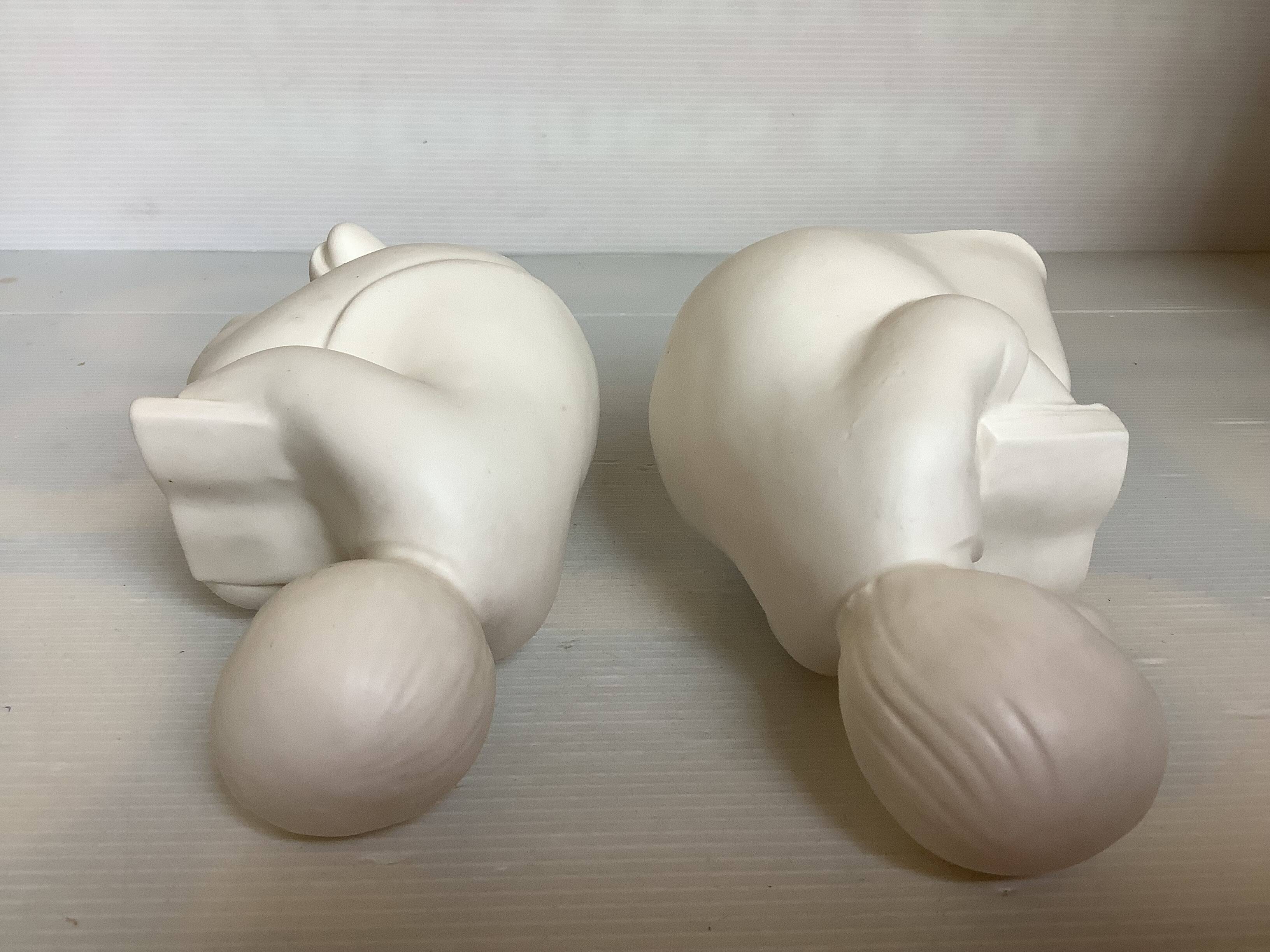 Pair of bookends with a matte white glaze for children.