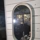 Oval mirror in white lacquer from the 1970s.