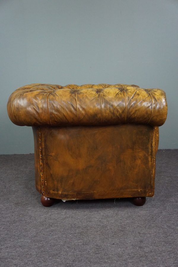 Patinated Chesterfield armchair