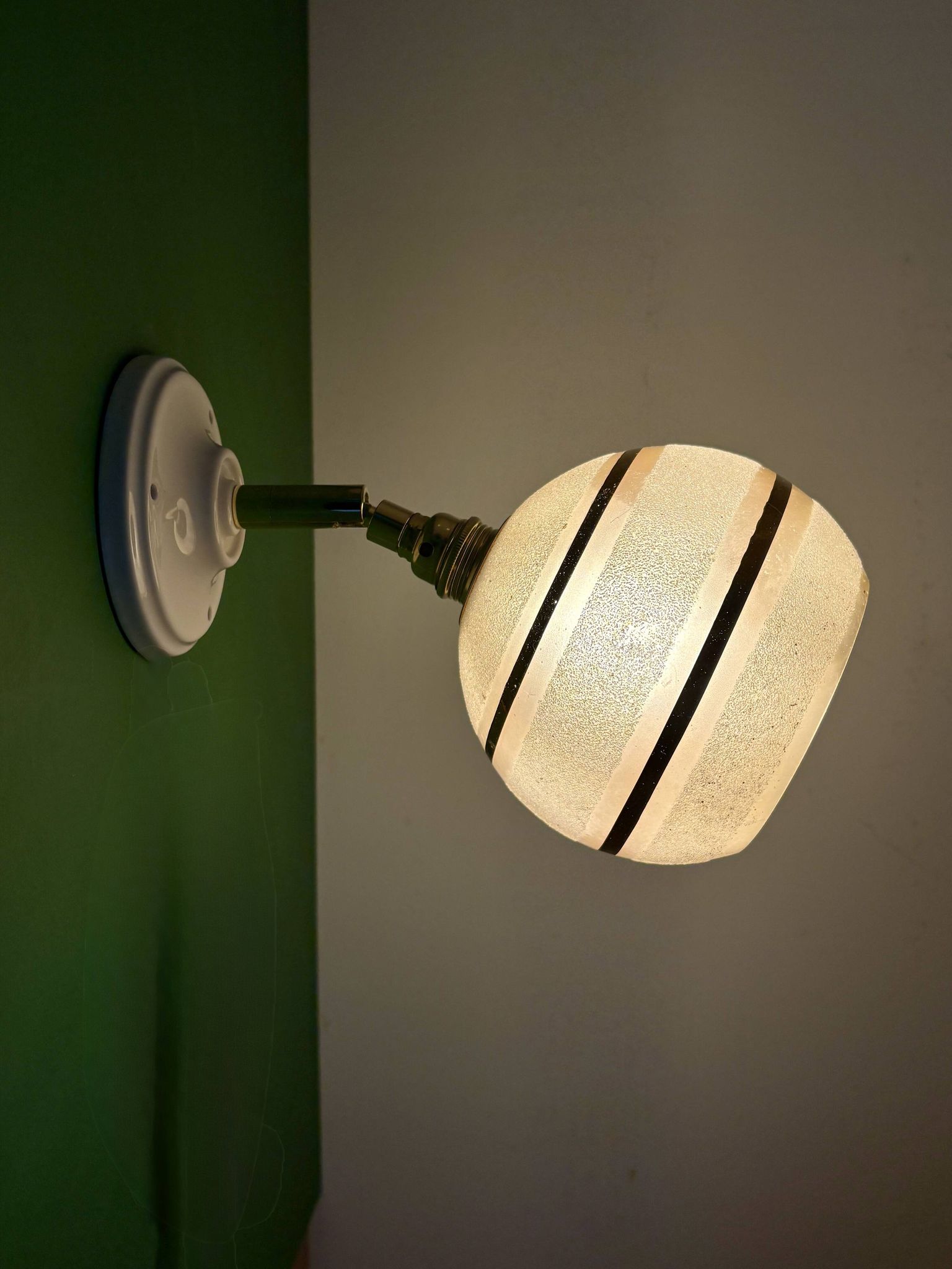 Vintage globe wall light in frosted yellow and gold glass.