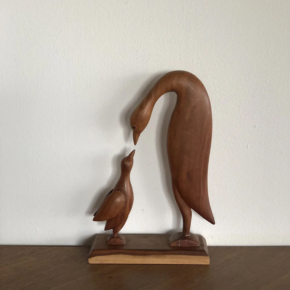 Sculpture of a goose feeding its young