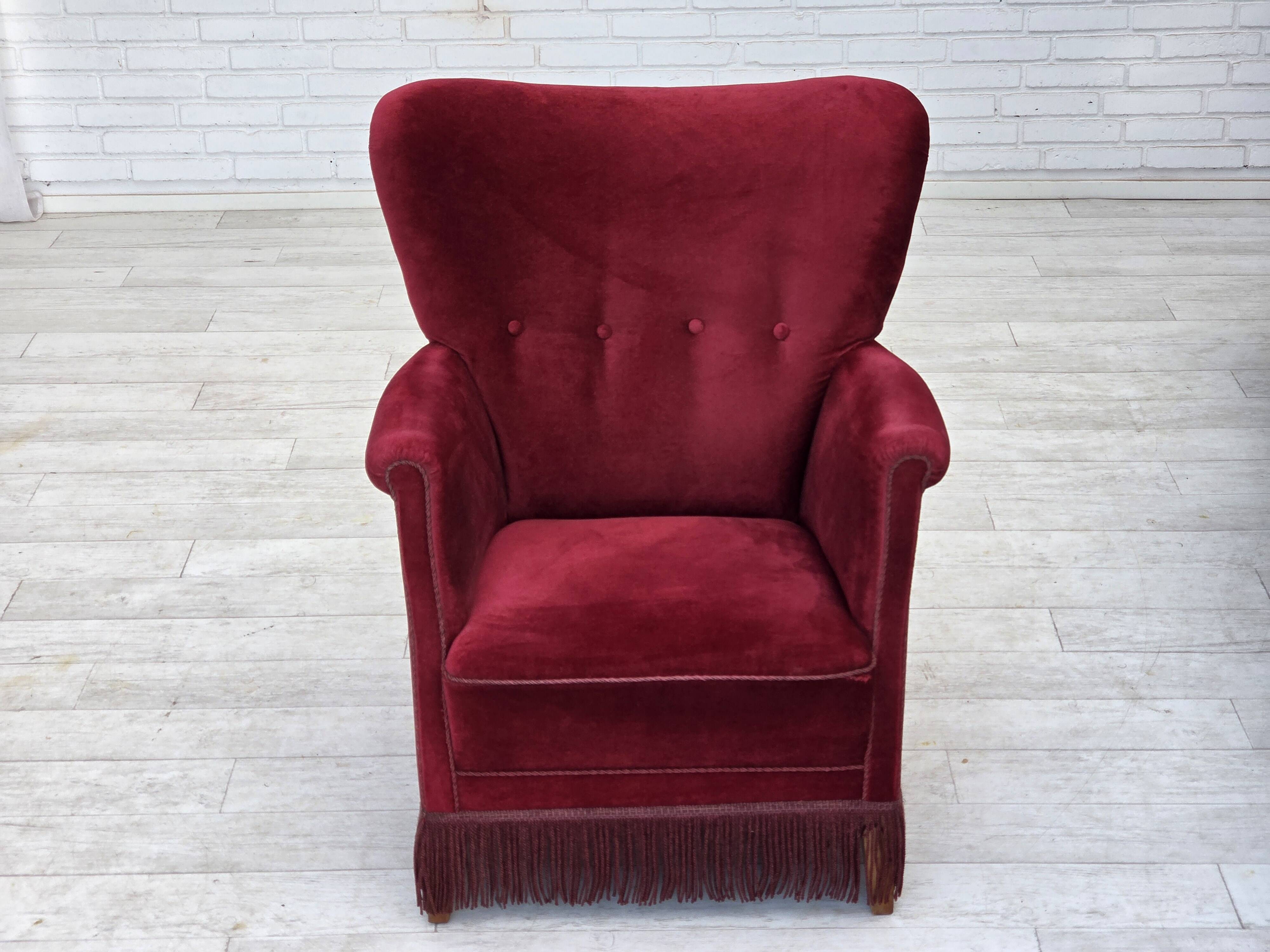 1970s, Danish armchair, cherry-red furniture velour, oak wood legs.