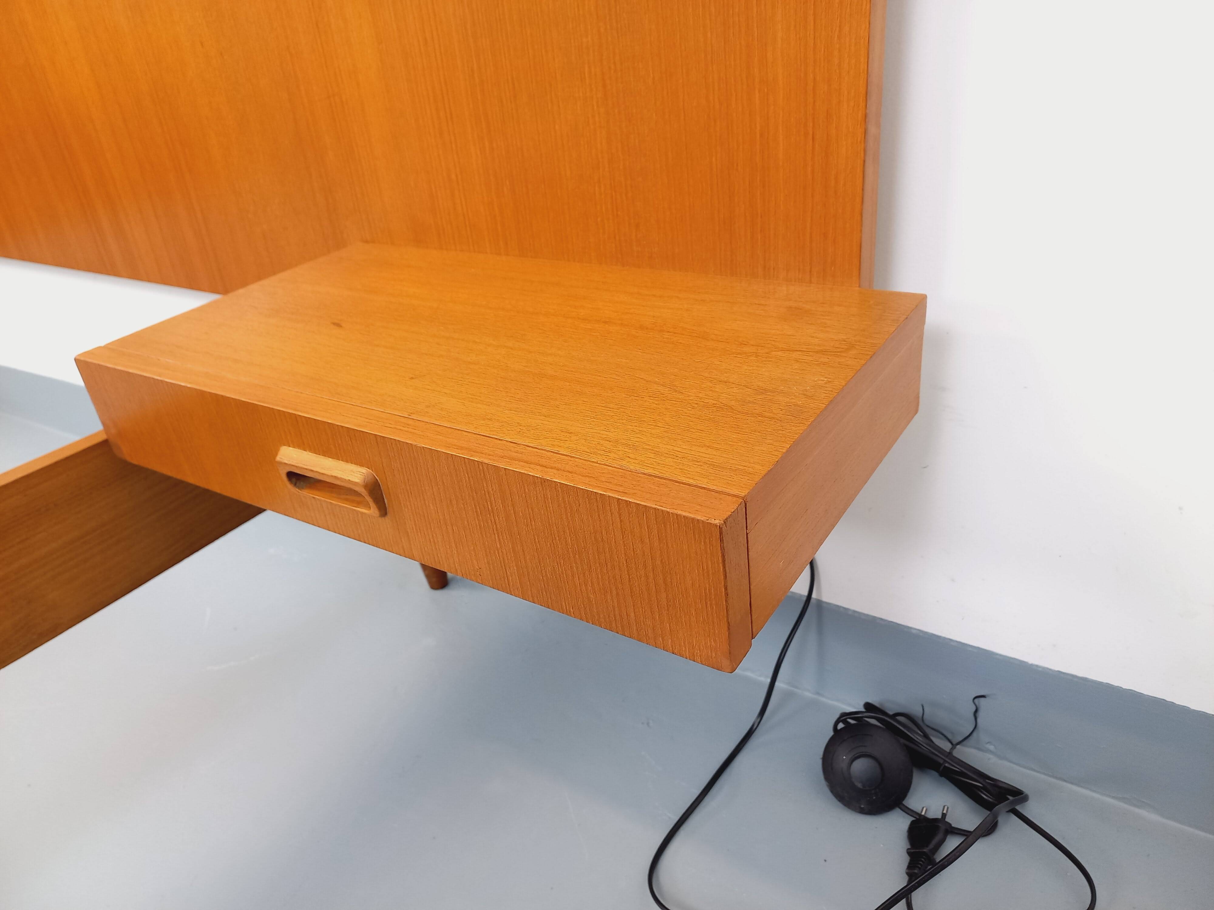 Double bed in vintage Scandinavian style from the 1960s with bedside tables.
