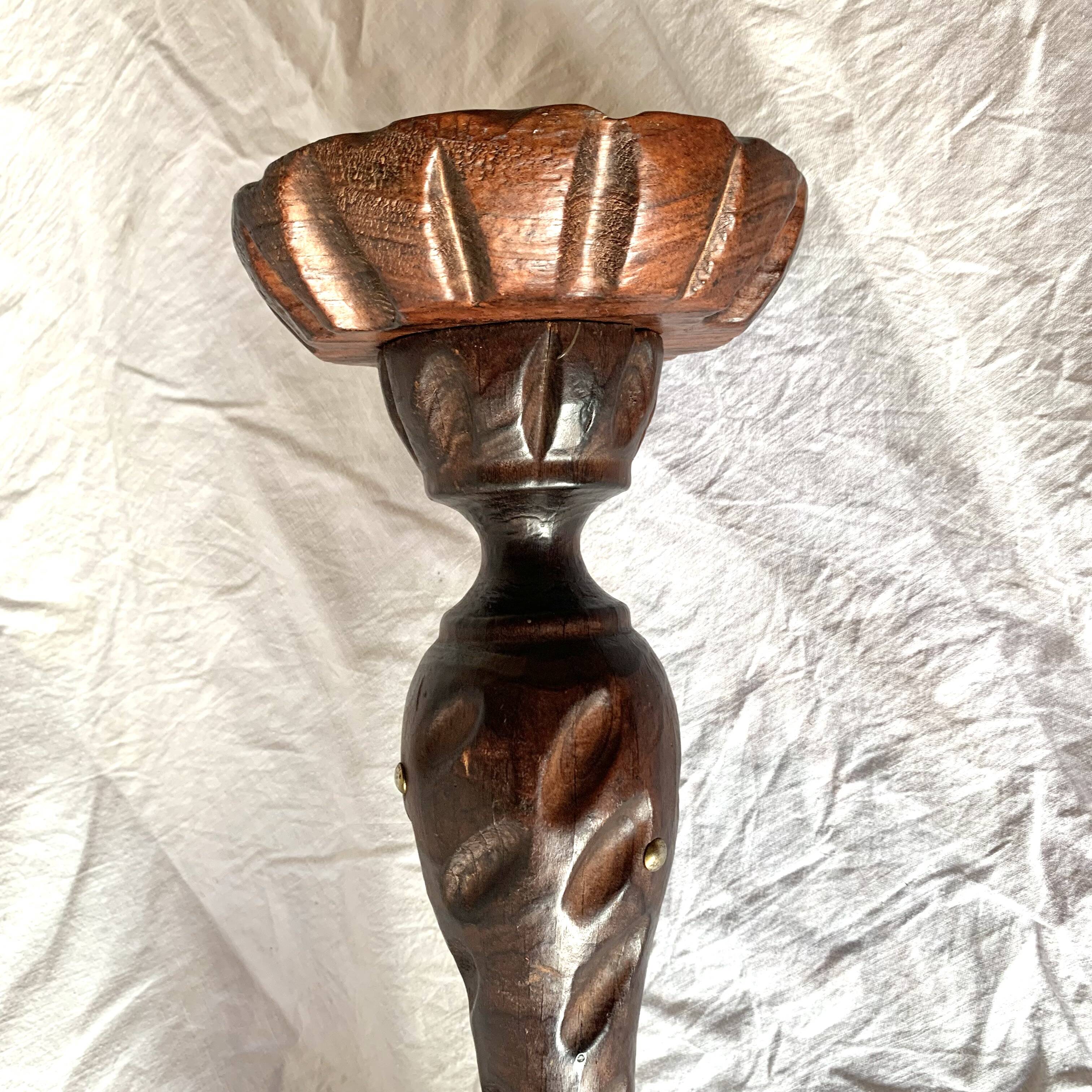 Old ashtray on carved wooden stand