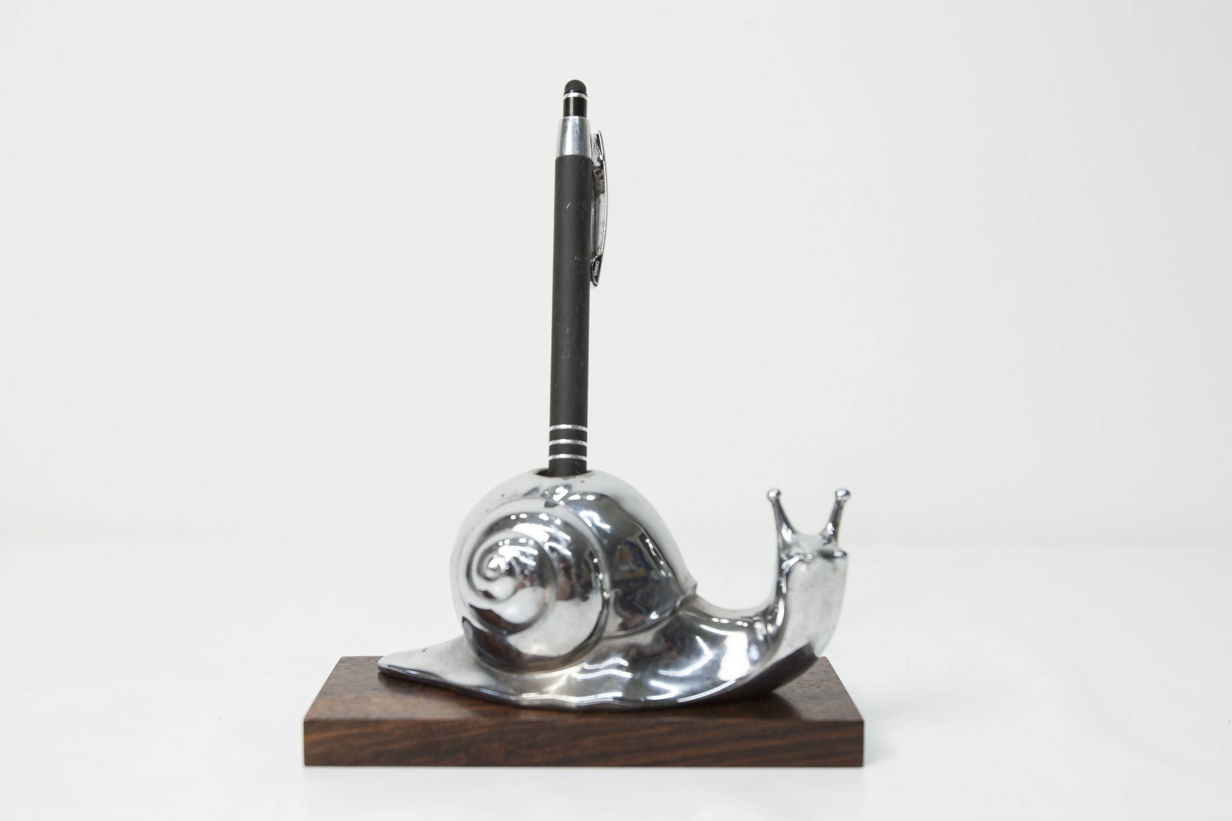 Silver snail candlestick on a teak base 1960