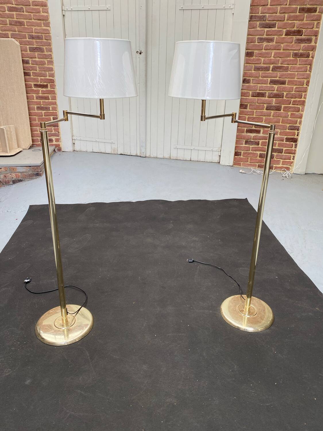 Pair of articulated floor lamps