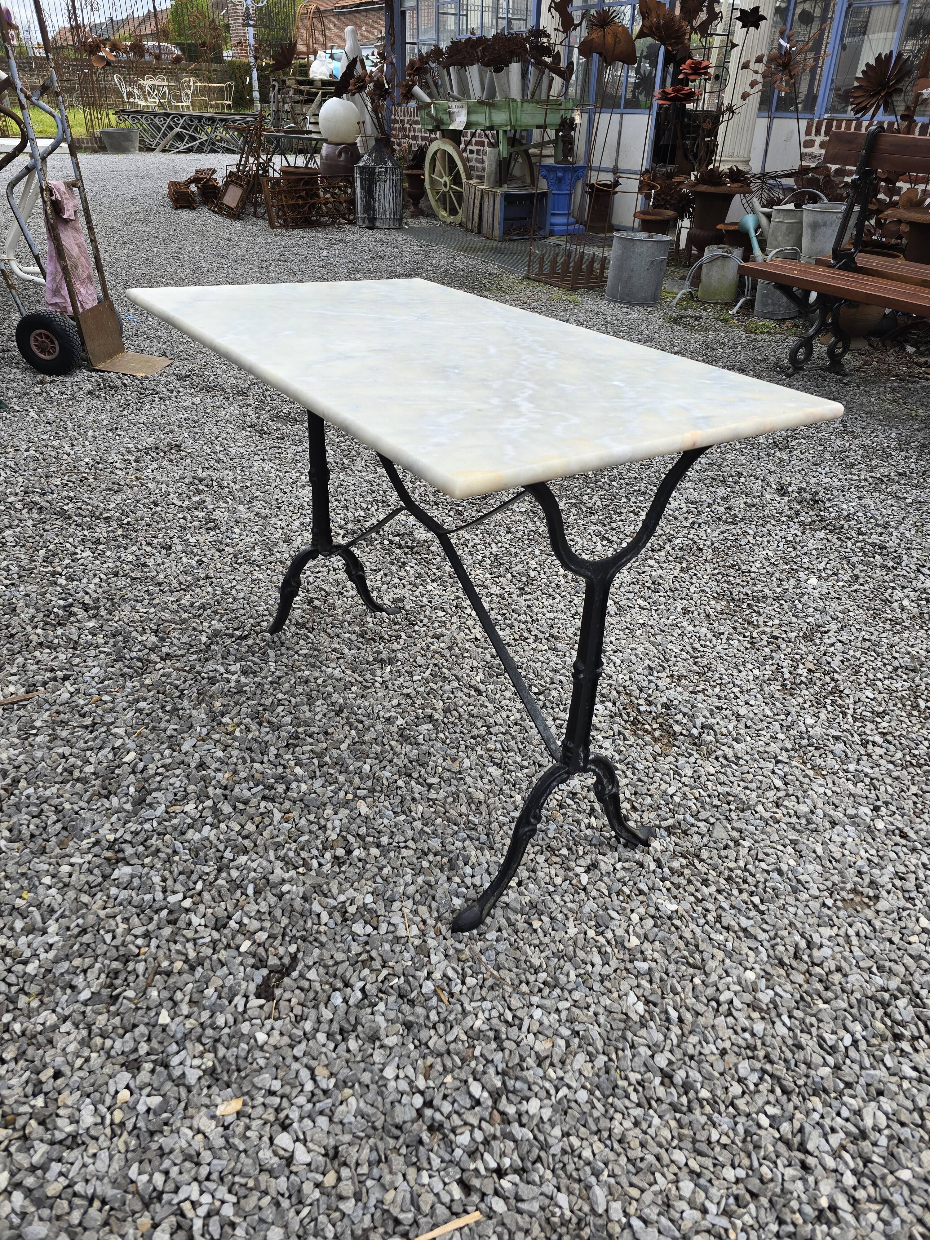 Bistro table with marble top and cast iron base
