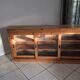 Antique wooden sideboard with three sliding glass doors.