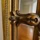 Large Napoleon III mirror 130 × 93 cm — gilded frame sculpted with ribbon pediment.